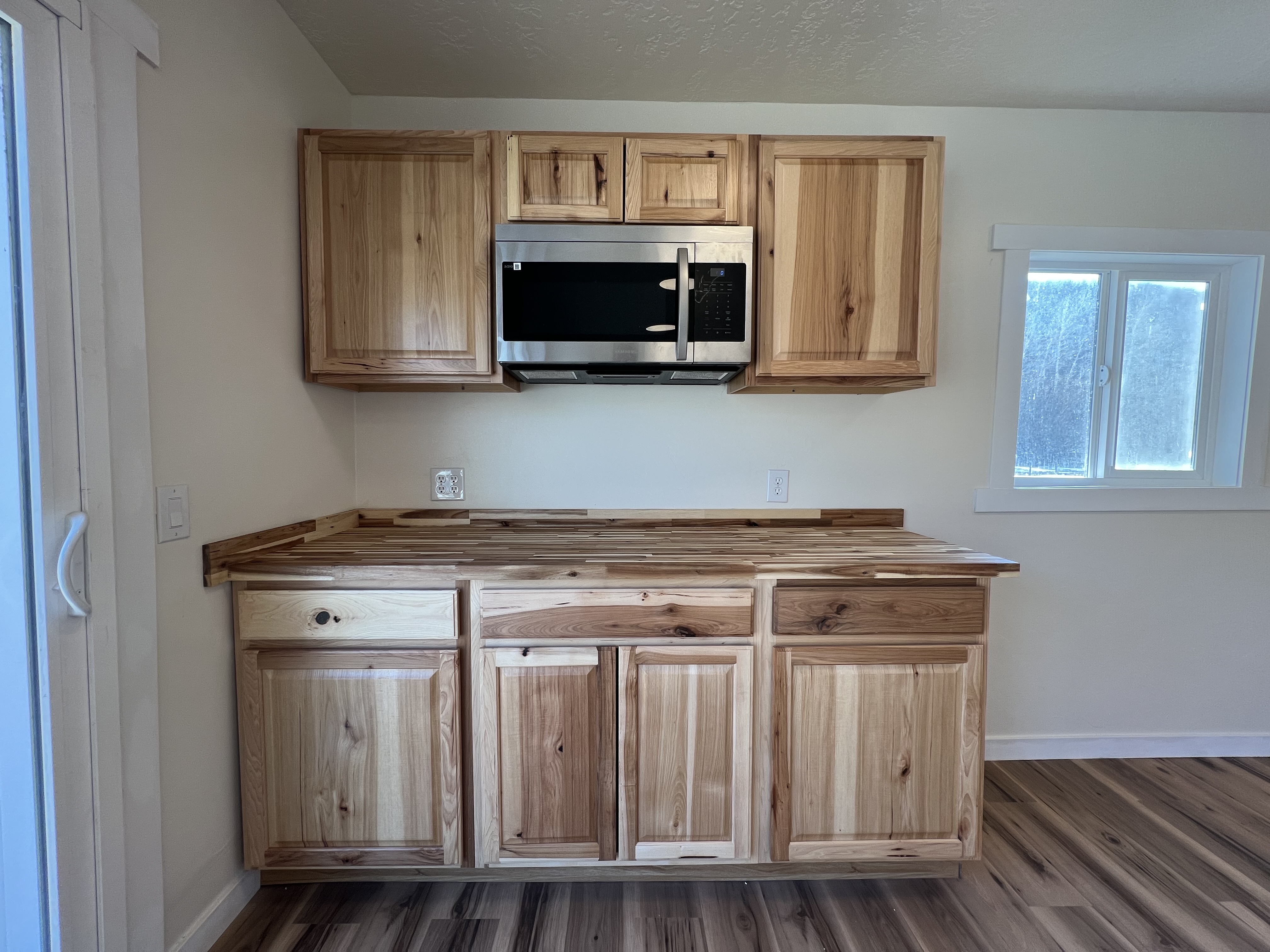 ADU Conversion of existing garage custom kitchen, with microwave, butcher block countertop and cabinetry.