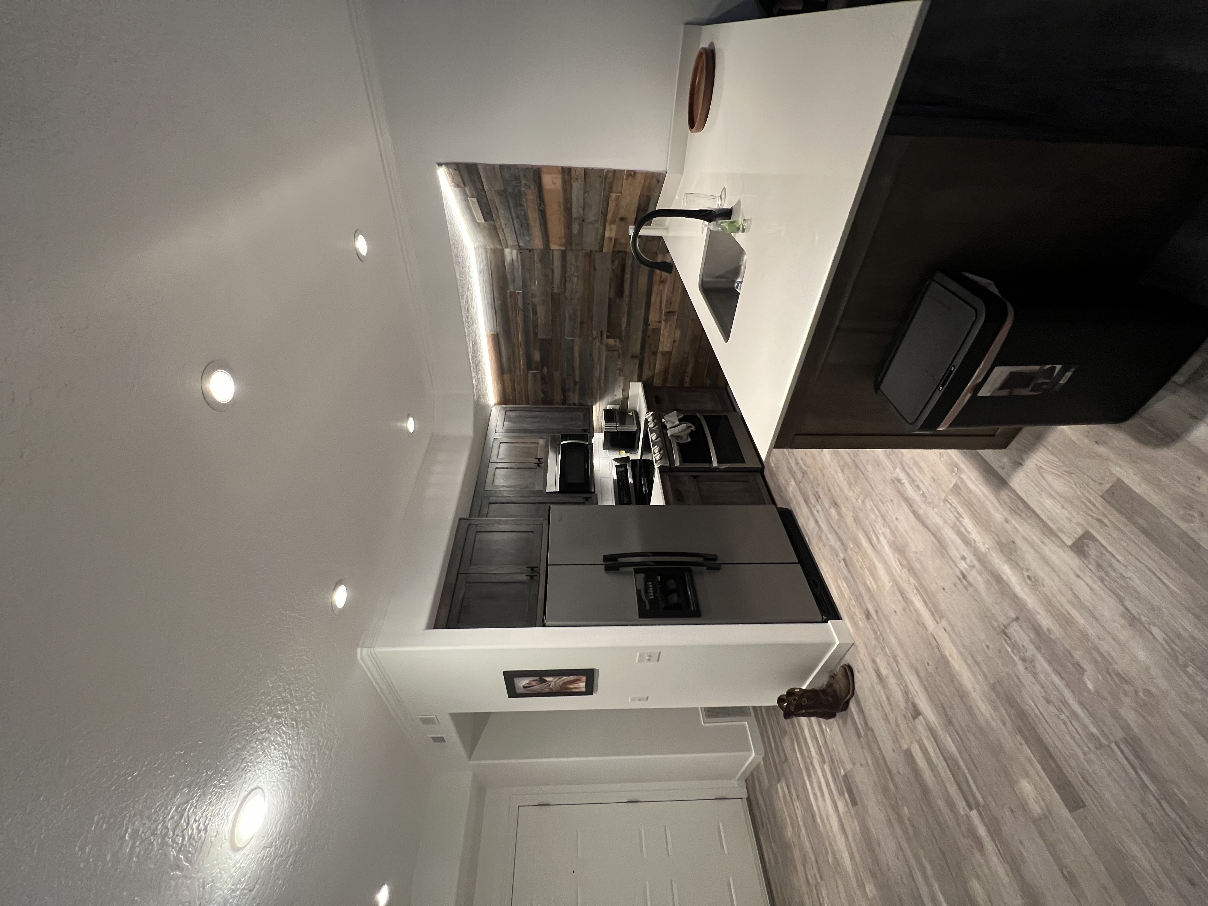 Custom Kitchen Remodel with custom cabinets and a large island with quartz counter top and reclaimed wood accent wall.